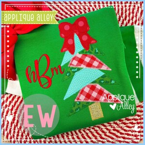 May include: Green Christmas tree applique with a red bow, gingham and polka dot accents, and a gold glitter trunk. The shirt features the text "Applique Alley" and a monogram. The letters "EW" are in a pink circle.