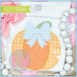 May include: A white t-shirt featuring an orange and yellow checked pumpkin with a blue and white polka dot bow on top. The text "Applique" is visible on the shirt.