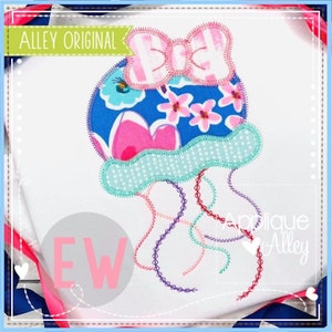 May include: Applique design of a blue and pink jellyfish with a pink bow on top. The jellyfish has a blue body with pink flowers and a turquoise and white dotted bottom. The tentacles are red, purple, and turquoise. The design is on a white background with the text "Applique Alley" in the bottom right corner.