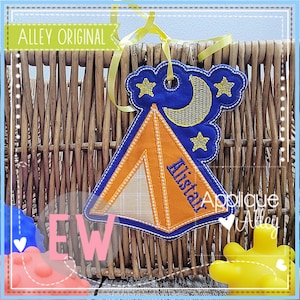 May include: A blue and orange embroidered applique of a tent with a moon and stars. The tent has the name "Ellistar" embroidered on it.