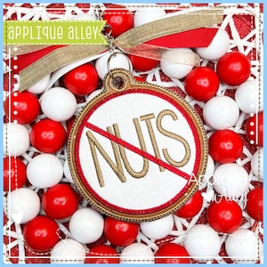 May include: A red and gold round ornament with a white background and the word "NUTS" with a diagonal line through it. The ornament is surrounded by red and white candy.