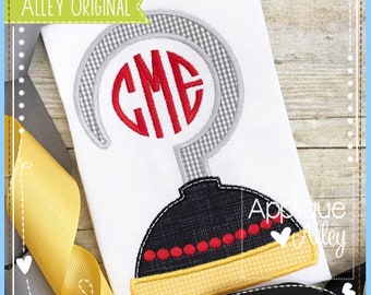 May include: White fabric with a design featuring a red monogram within a gray and white checkered hook shape. Below the hook is a black and yellow design with red dots. The text "Alley Original" is in a green banner.
