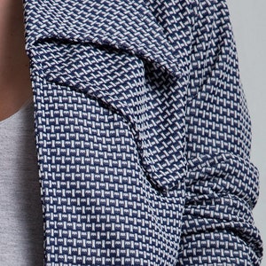 May include: A blue and white patterned blazer with a collar that can be worn up or down.