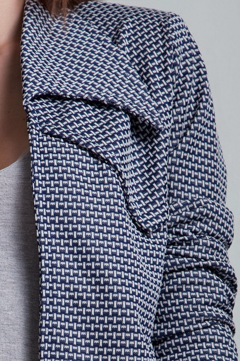 May include: A blue and white patterned blazer with a collar that can be worn up or down.