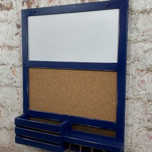 May include: A blue wooden wall organizer with a white dry erase board, a cork board, a small shelf, and hooks.