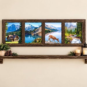 May include: A rectangular dark brown wooden wall shelf featuring a four-pane window frame display. The frame contains four distinct nature scenes including a cabin, a mountain lake, a deer, and a waterfall. A small plant and lantern sit on the shelf.