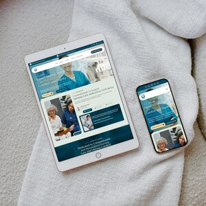 May include: A white tablet and smartphone displaying a website with the text "Expert Nursing Home Care focused on Comfort and Dignity." The website features images of healthcare professionals and elderly individuals.