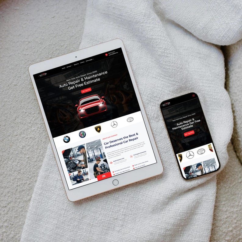 May include: A white tablet and a black smartphone displaying a website for auto repair and maintenance. The website features a red car graphic and the text "Auto Repair & Maintenance Get Free Estimate". The tablet and phone are on a white, textured surface.