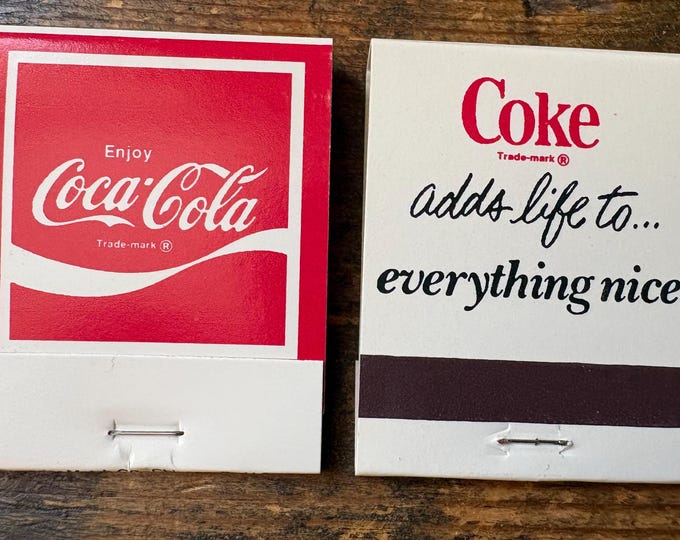 Two Unused Coca-Cola Matchbooks, 1970s Slogan Logo, Unstruck Coke Matches: “COKE ADDS LIFE”