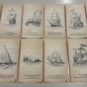 May include: A collection of vintage cards featuring detailed black and white illustrations of various sailing ships. Each card has a title describing the ship's type and origin, such as "Pirate Ship" and "Viking Ship."