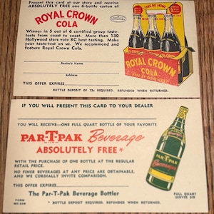 May include: Vintage promotional cards for Royal Crown Cola and Par-T-Pak Beverage. The Royal Crown card features a carton of cola bottles. The Par-T-Pak card showcases a bottle illustration. Both cards have text offering free beverages.