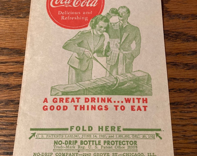 Vintage Coca Cola Dry Server Bottle Drip Protector Sleeve featuring Large Red COKE "Delicious and Refreshing" Logo; Couple Grilling Hot Dogs