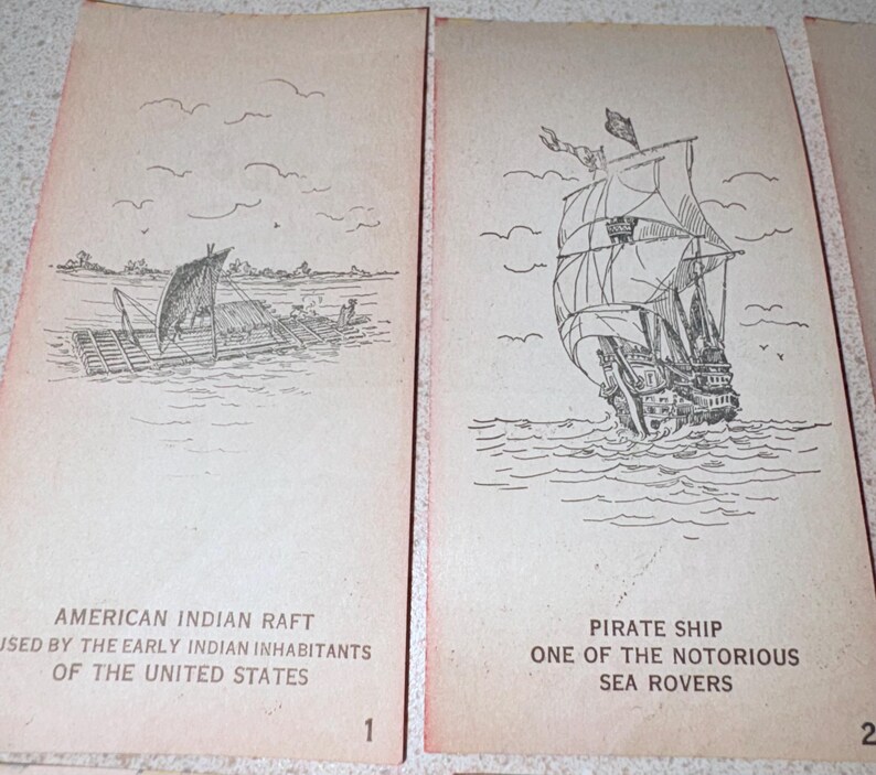 May include: Two vintage cards with black and white illustrations. One depicts an American Indian raft with text: "AMERICAN INDIAN RAFT USED BY THE EARLY INDIAN INHABITANTS OF THE UNITED STATES." The second card shows a pirate ship with text: "PIRATE SHIP ONE OF THE NOTORIOUS SEA ROVERS."