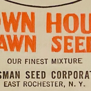 May include: Orange and black text on a white background reads "Town House Lawn Seed Our Finest Mixture Crosman Seed Corporation East Rochester, N.Y."