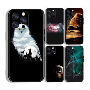May include: A collection of black phone cases featuring various designs. One case displays a snowy owl over a silhouette of a castle. Other cases showcase images of glasses, a sorting hat, a character's face, and a wand with symbols.