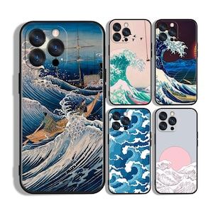 May include: A collection of phone cases featuring Japanese-inspired wave art. The cases showcase various designs with blue, white, and pink color schemes. One case depicts a boat on a wave, while others display wave patterns and a sunset.