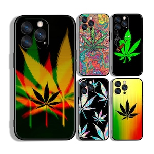 May include: A selection of phone cases with cannabis leaf designs. The cases display diverse artistic styles, including vibrant psychedelic patterns, a green leaf character smoking, and a black case with a colourful leaf design. The cases have a black border.