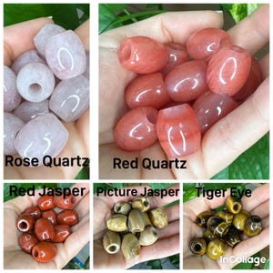 May include: A collection of five sets of barrel-shaped gemstone beads labeled Rose Quartz, Red Quartz, Red Jasper, Picture Jasper, and Tiger Eye. Each set features smooth, polished stones with distinct natural colors, textures, and patterns.