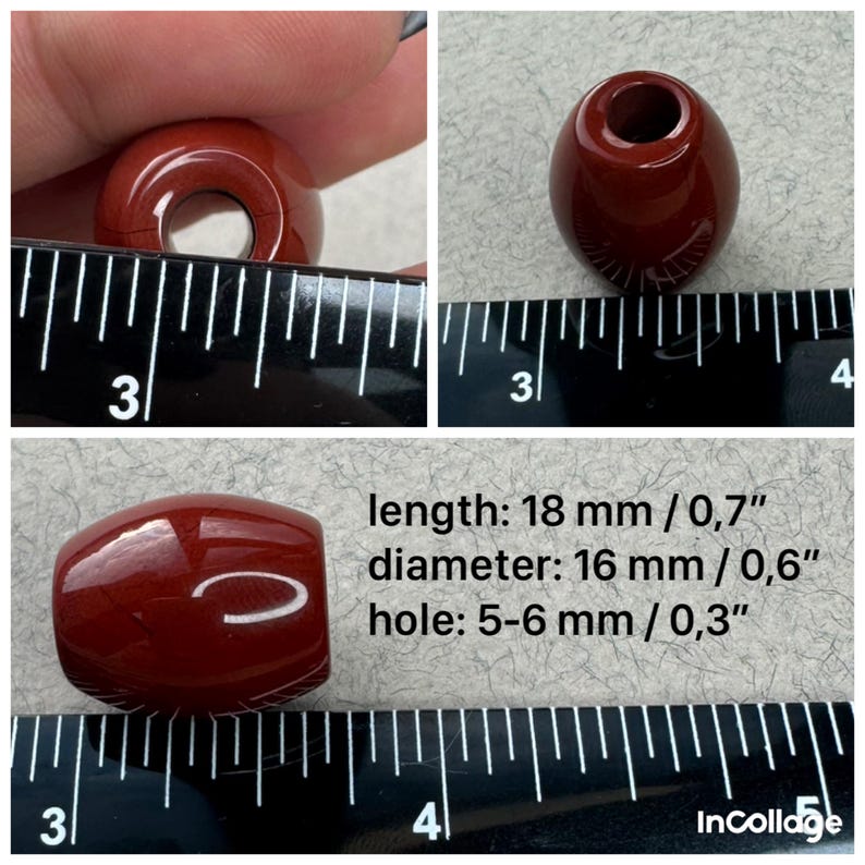 May include: A glossy, dark red, barrel-shaped bead with a central hole. The bead measures 18 mm or 0.7 inches in length, 16 mm or 0.6 inches in diameter, and features a hole size of 5-6 mm or 0.3 inches, as indicated by the visible ruler.