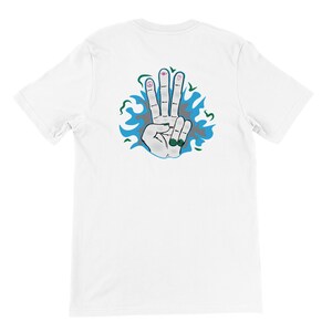 May include: White t-shirt with a blue and gray design of a hand with four fingers raised. The fingers have various symbols drawn on them.