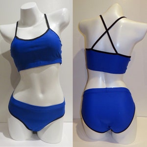 May include: A royal blue bikini top and bottom with black trim. The top has a criss-cross back strap.