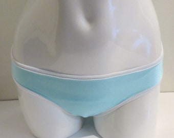 May include: Light blue underwear with a white trim. The underwear is on a white mannequin.