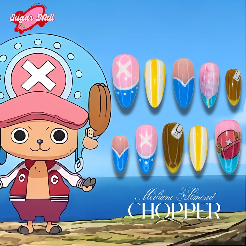 May include: Almond-shaped nail art designs inspired by the anime character Chopper from One Piece. The nails are painted in pink, blue, yellow, and brown, with designs reflecting Chopper's look. The text "Medium Almond CHOPPER" is displayed. The Sugar Nail logo is in the top left corner.
