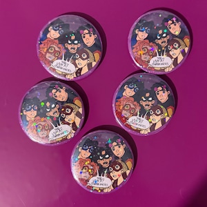 May include: Five round, clear buttons with a comic-style illustration of a group of people in superhero costumes. The text "The What Conference" is in a speech bubble. The buttons are on a purple background.