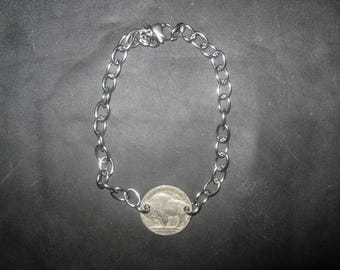 May include: A silver chain bracelet with a silver buffalo nickel coin charm.