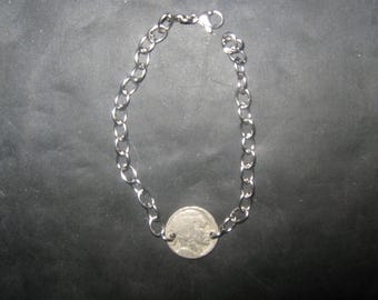 May include: A silver chain necklace with a silver coin pendant.