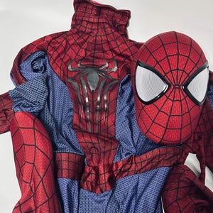 May include: A red and blue Spider-Man costume with a matching mask. The costume has a web pattern and a large spider emblem on the chest. The mask features white eye coverings and black outlines.