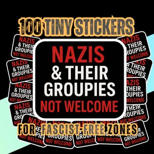 May include: A collection of 100 tiny stickers with a black background. The stickers have the text "NAZIS & THEIR GROUPIES NOT WELCOME" in red and white. The stickers are designed for fascist-free zones.
