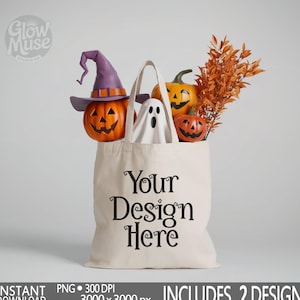 May include: A beige tote bag filled with Halloween decorations, including carved pumpkins, a ghost, and fall foliage. The bag has the text "Your Design Here" in black script. A purple witch hat sits atop one pumpkin.
