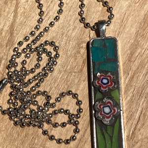 Thin mosaic pendant with red, white and blue flowers