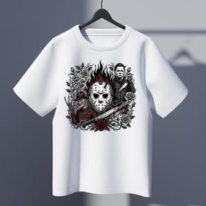May include: A white short-sleeve t-shirt featuring a graphic print of a hockey mask, a character in a striped sweater with a clawed glove, and a character in a dark jumpsuit holding a knife, all surrounded by dark roses and thorny vines.