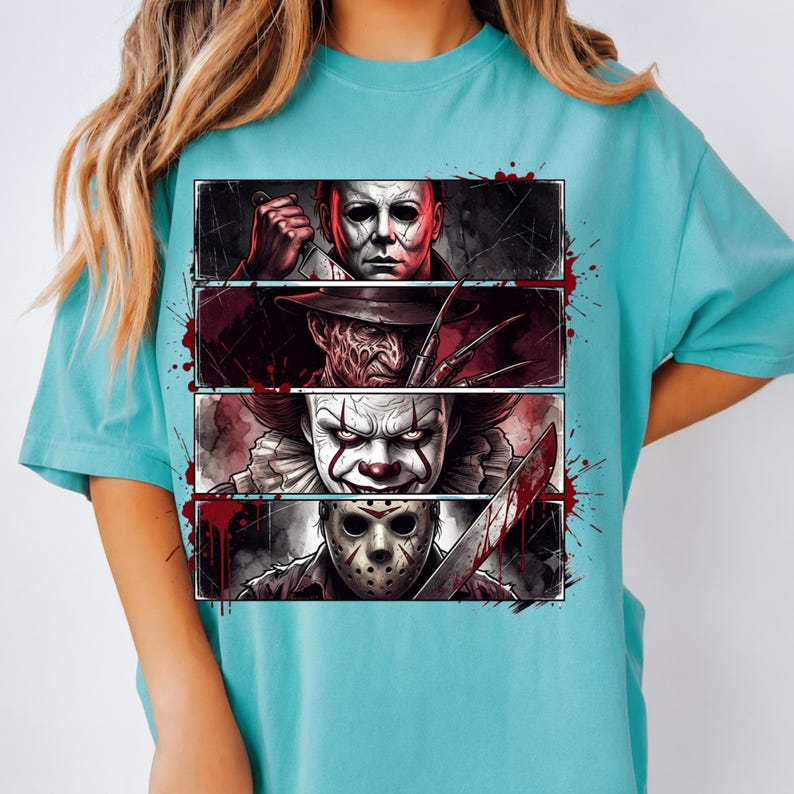 May include: A turquoise short-sleeve t-shirt featuring a graphic print of four horror movie characters arranged in horizontal panels. The design includes Michael Myers with a knife, Freddy Krueger with clawed fingers, Pennywise the clown, and Jason Voorhees wearing a hockey mask, all accented with red blood splatter effects.