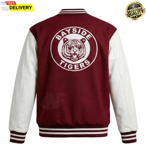 May include: Maroon and white varsity jacket with the text "Bayside Tigers" and a tiger graphic on the back. The jacket has white sleeves and striped cuffs and hem. A "Premium Quality" seal is in the upper right corner.