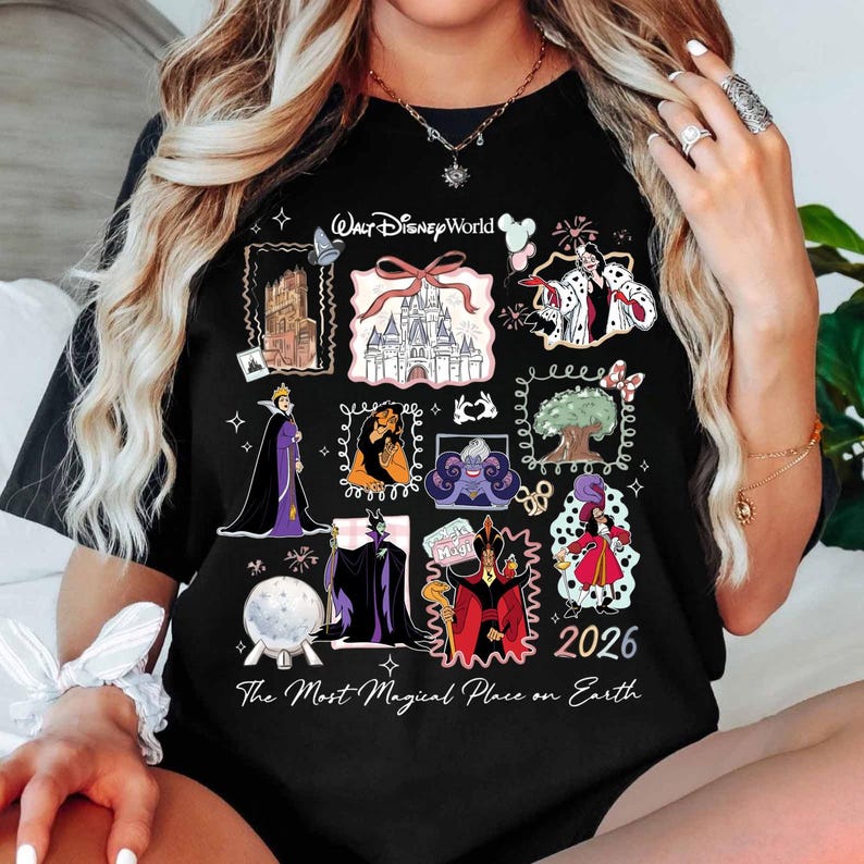 May include: Black t-shirt featuring a collage of Disney characters and landmarks. The design includes images of villains, castles, and the text "Walt Disney World" and "2026". The phrase "The Most Magical Place on Earth" is also printed on the shirt.