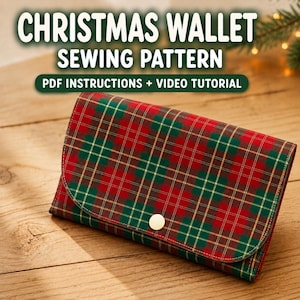 May include: A rectangular wallet featuring a red, green, and gold plaid pattern with a single gold snap closure. The text CHRISTMAS WALLET SEWING PATTERN PDF INSTRUCTIONS + VIDEO TUTORIAL is displayed above the wallet in white and green.