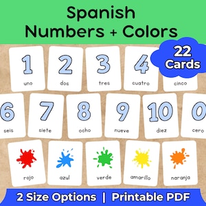 May include: Educational flashcards featuring Spanish numbers and colors. The cards display numbers 1-10 and zero, along with color names in Spanish. The image includes a blue cloud graphic with the text "22 Cards". The text "2 Size Options | Printable PDF" is also visible.