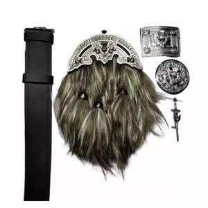 May include: A traditional Scottish kilt outfit, featuring a black leather belt, a fur sporran with silver accents, a belt buckle, a round emblem, and a decorative sword pin. The sporran has a gray and white fur texture.