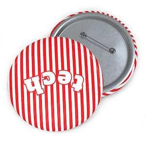 May include: A round button with a red and white striped pattern and the word "tech" in white. The button has a metal pin back and a red and white striped edge. The button is a fun accessory.