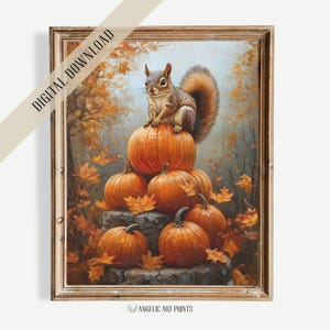May include: A framed digital download print featuring a squirrel perched atop a pile of orange pumpkins. The artwork has a warm color palette with autumn leaves and a forest background. The text "DIGITAL DOWNLOAD" is visible.