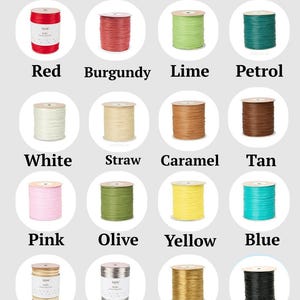 May include: A color chart titled Raffia color displaying sixteen spools of raffia ribbon in various shades including red, burgundy, lime, petrol, white, straw, caramel, tan, pink, olive, yellow, blue, walnut, silver, gold, and black.