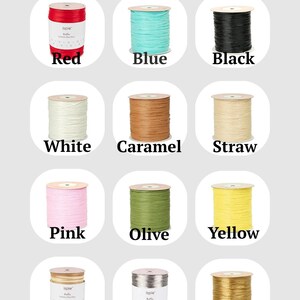 May include: A collection of twelve spools of raffia yarn arranged in a grid, each labeled with its color name including red, blue, black, white, caramel, straw, pink, olive, yellow, walnut, silver, and gold, with the title Raffia color above.