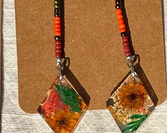 Exotic. Somewhat tribal looking, these drop earrings are colorful, fun, and show your great sense of adventure.