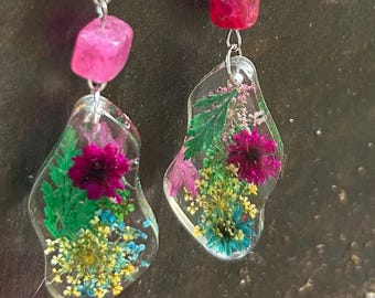 Enchanting. Dangle earrings, unique shape, real pressed flowers, purple and tan beads, clear resin. Fun to wear!