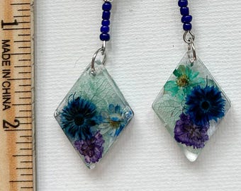 Alluring. Shades of blue are fun and exciting. They are lightweight and feel great swinging on your neck.
