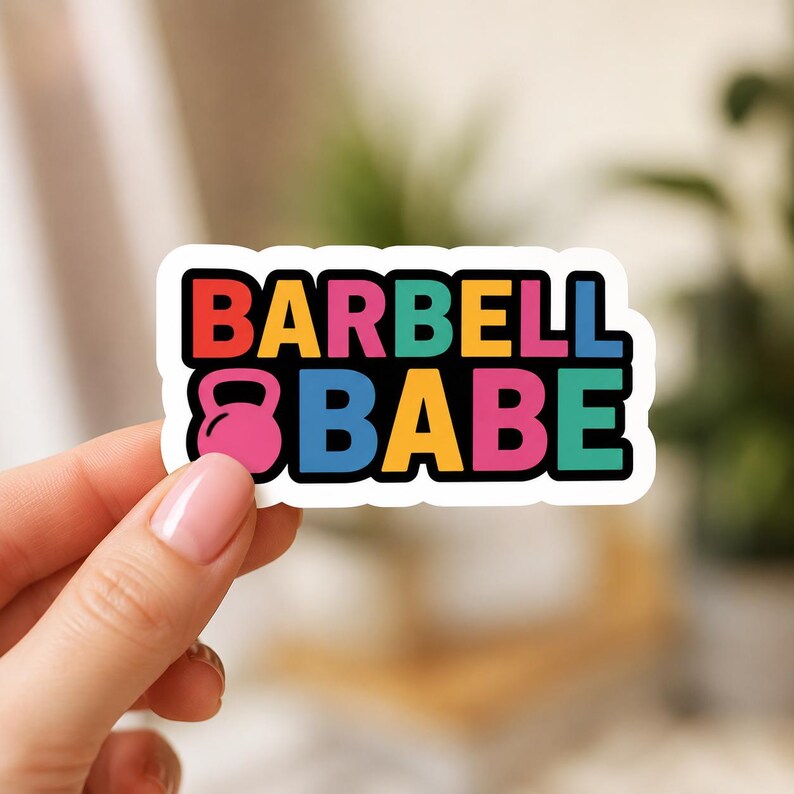 A hand holding a rectangular sticker with rounded edges and a white border. This view shows the physical quality and shape of the various items in the workout sticker set, suitable for laptop decals or journals.