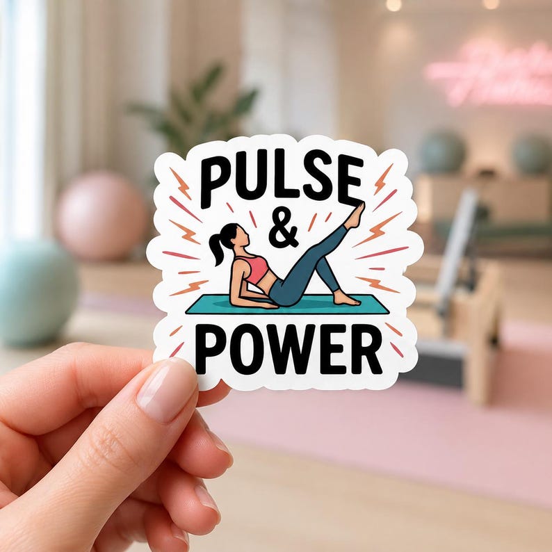 A hand holding a sticker that says PULSE & POWER with an illustration of a woman in pink workout gear. This dynamic sticker is a great way to celebrate movement and is perfect for decorating a cell phone case or journal.